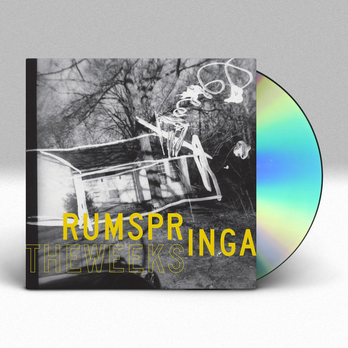 Image of a cd case with a cd sticking halfway out of the case against a grey to white gradient background. The artwork features a black and white image of a small house or cabin that looks old and like it is begining to fall apart. The cabin is surrounded by the woods. Underneath this image in yellow text it says Rumspringa. Below that to the left in a yellow outline it says the weeks.  There are white scribbles near the cabin and to the upper right corner of the artwork.